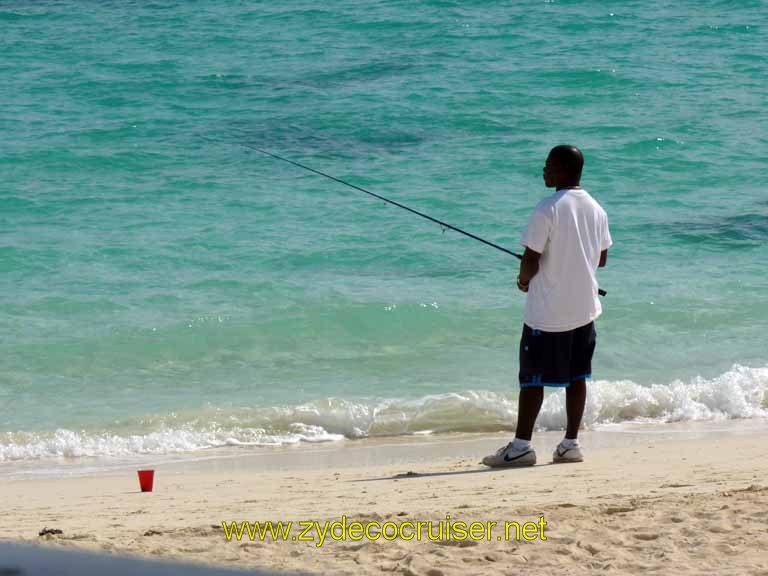 312: Carnival Sensation, Freeport, Bahamas, Man fishing near Billy Joe's Restaurant